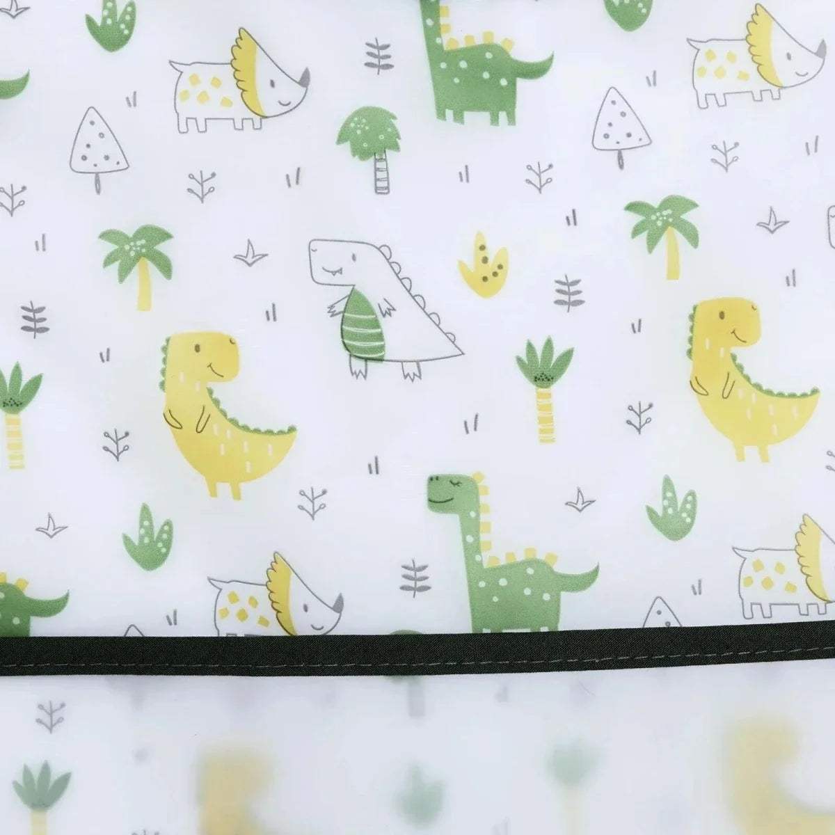 White baby bib fabric with repeating dinosaur and greenery prints and black trim border