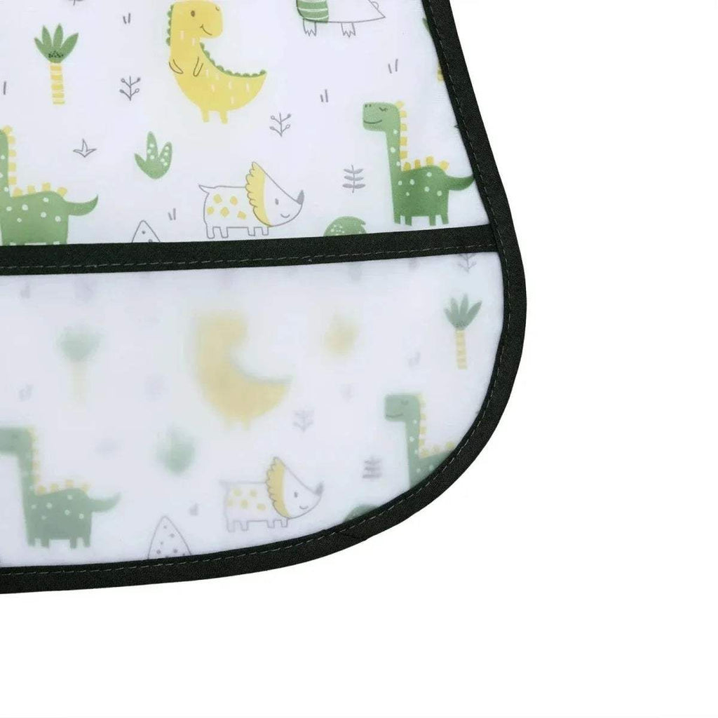 Corner view of white dinosaur baby bib with black trim and patterned fabric panel