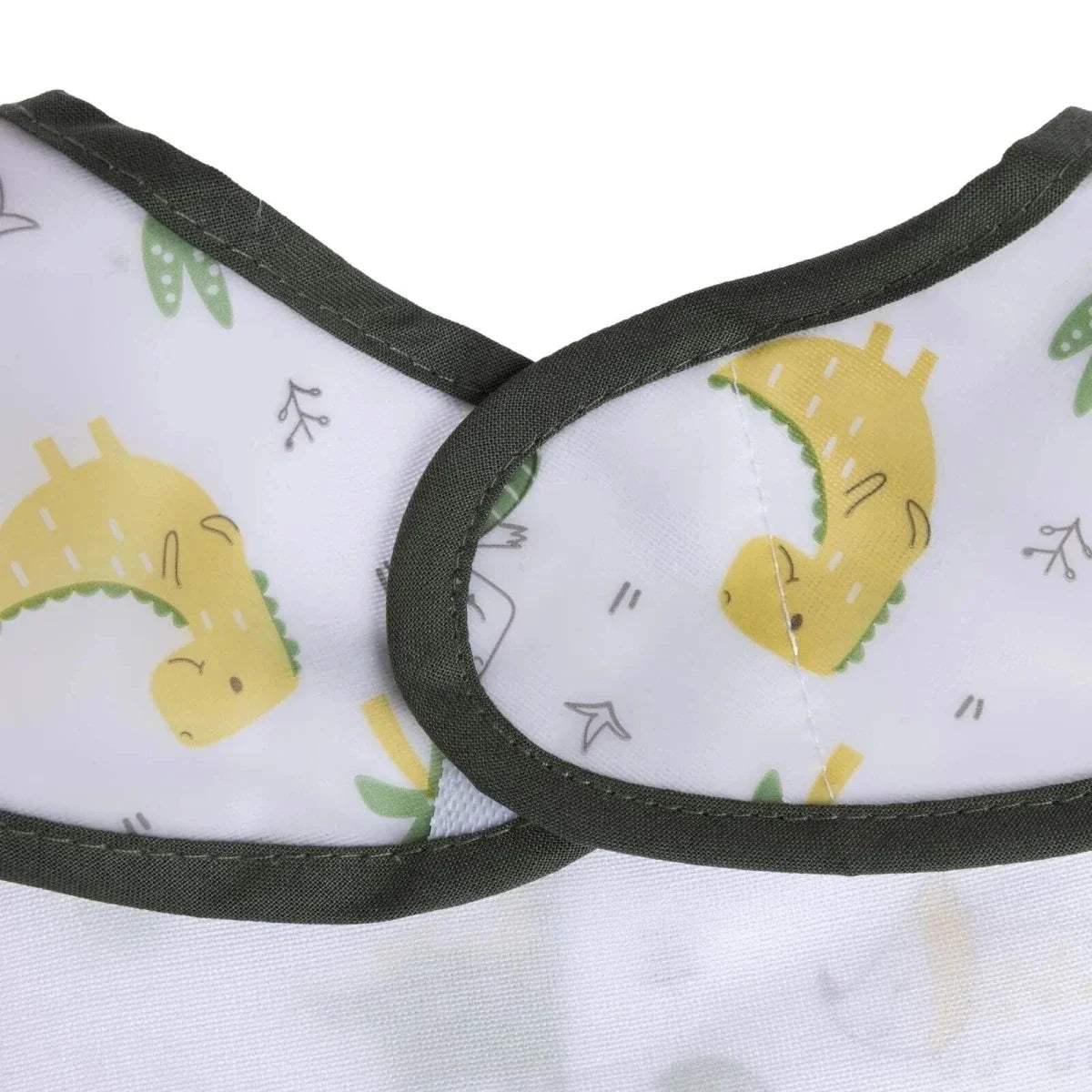 Neckline close-up of white dinosaur baby bib with black binding and printed dinosaur motifs
