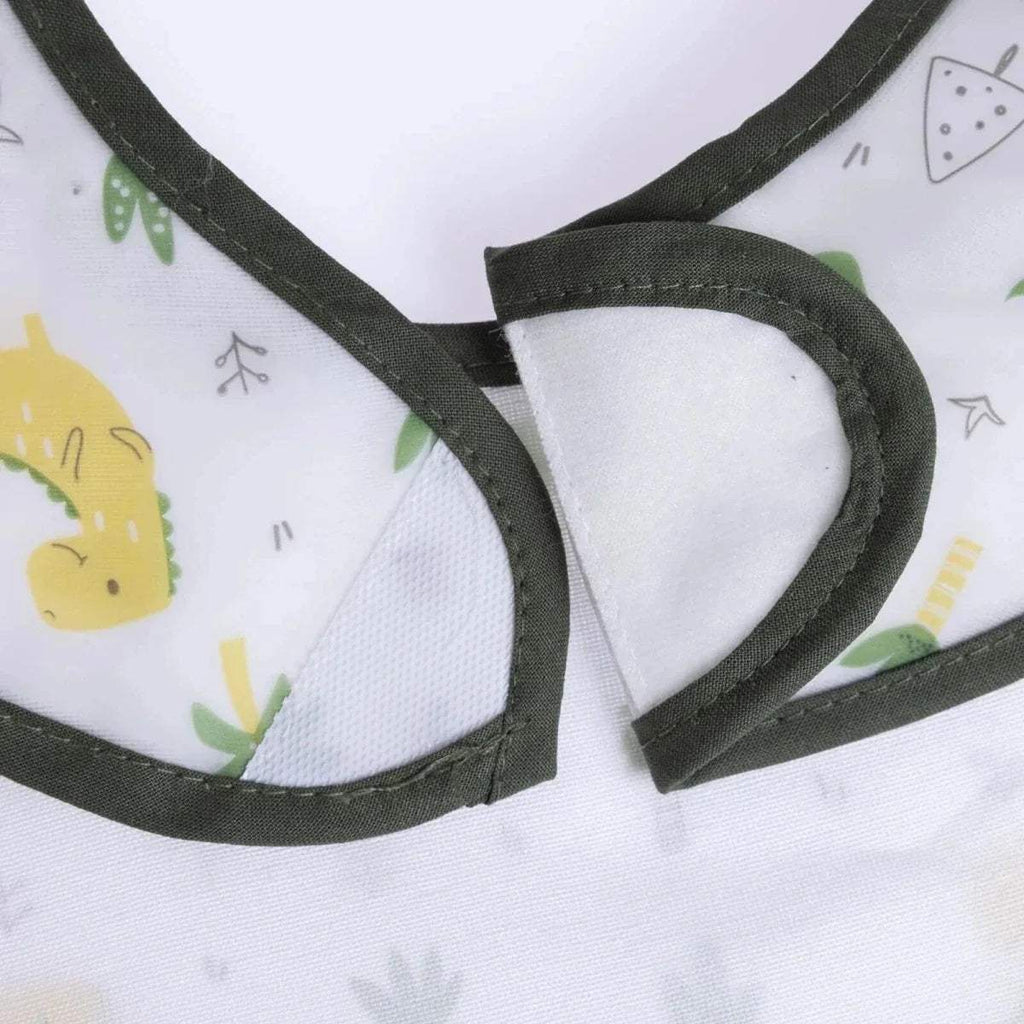 Neck opening detail of white dinosaur baby bib with black binding and patterned fabric