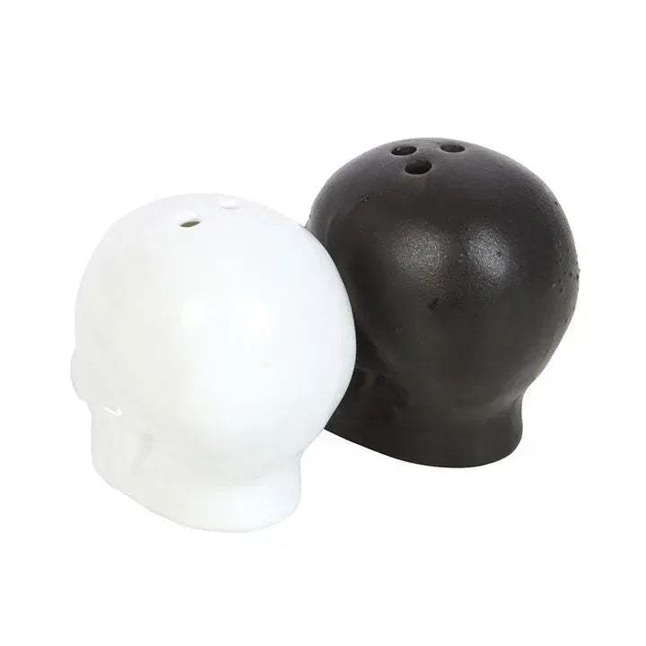 Skull-shaped salt and pepper shakers: dark and white skull heads facing opposite sides
