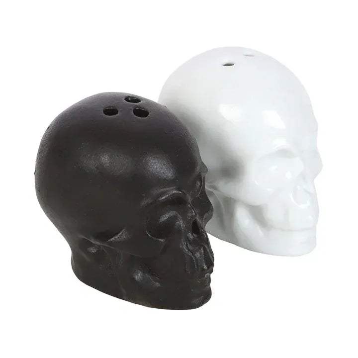 Skull salt and pepper shakers with dark skull in front and white skull behind, holes visible