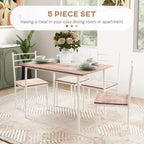 Five-piece dining set with brown tabletop and four white chairs in a bright room