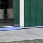 Steel base rails at the green storage shed doorway over a concrete surface