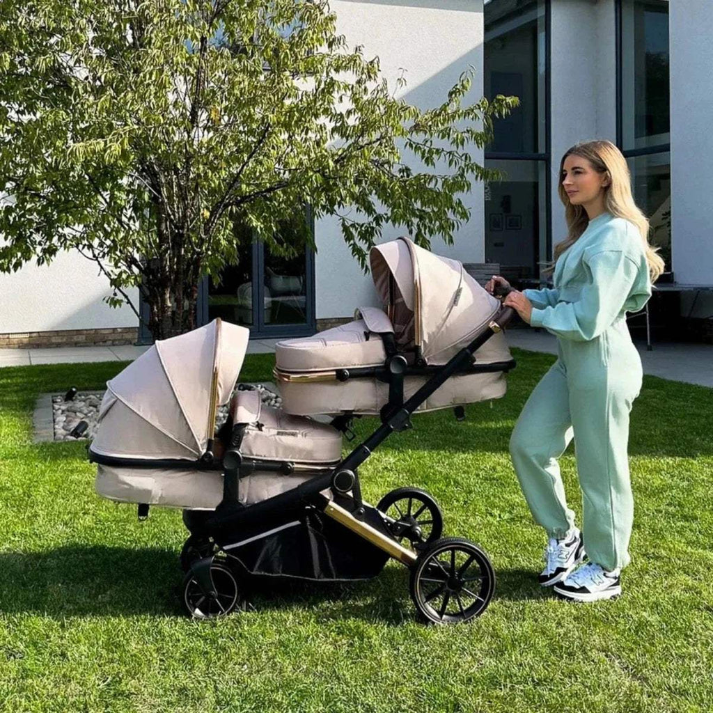 Black tandem pushchair with two seats on grass outdoors