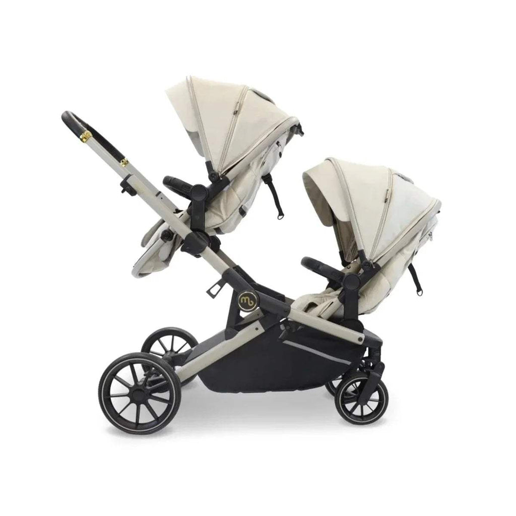 Ivory tandem pushchair with two seat units, side view, black canopy and wheels