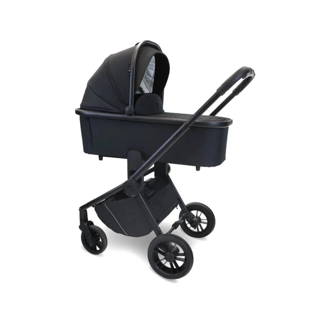 Black stroller with carrycot on frame, angled view showing wheels and handle bars