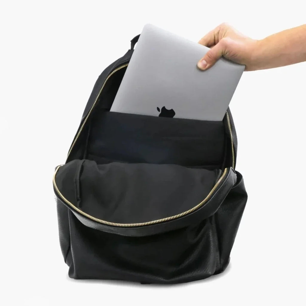 Changing backpack with front pocket pull-out mat insert held by hand