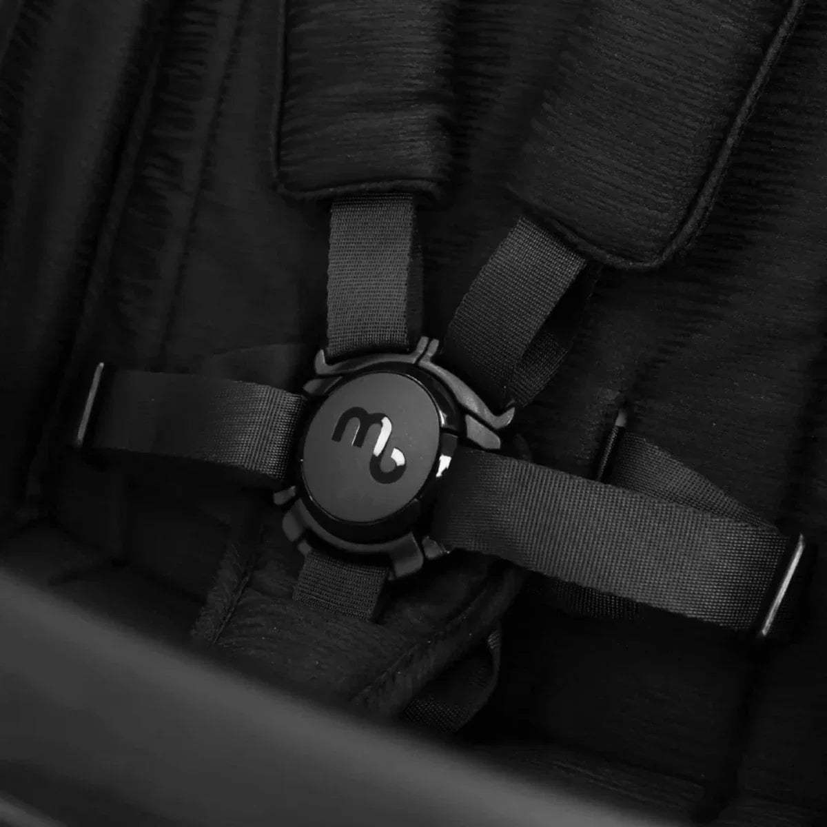 Black stroller harness close-up with mybabie circular control and buckle straps