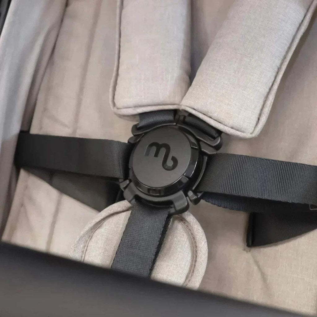 Camel stroller harness close-up with round clasp and seat straps