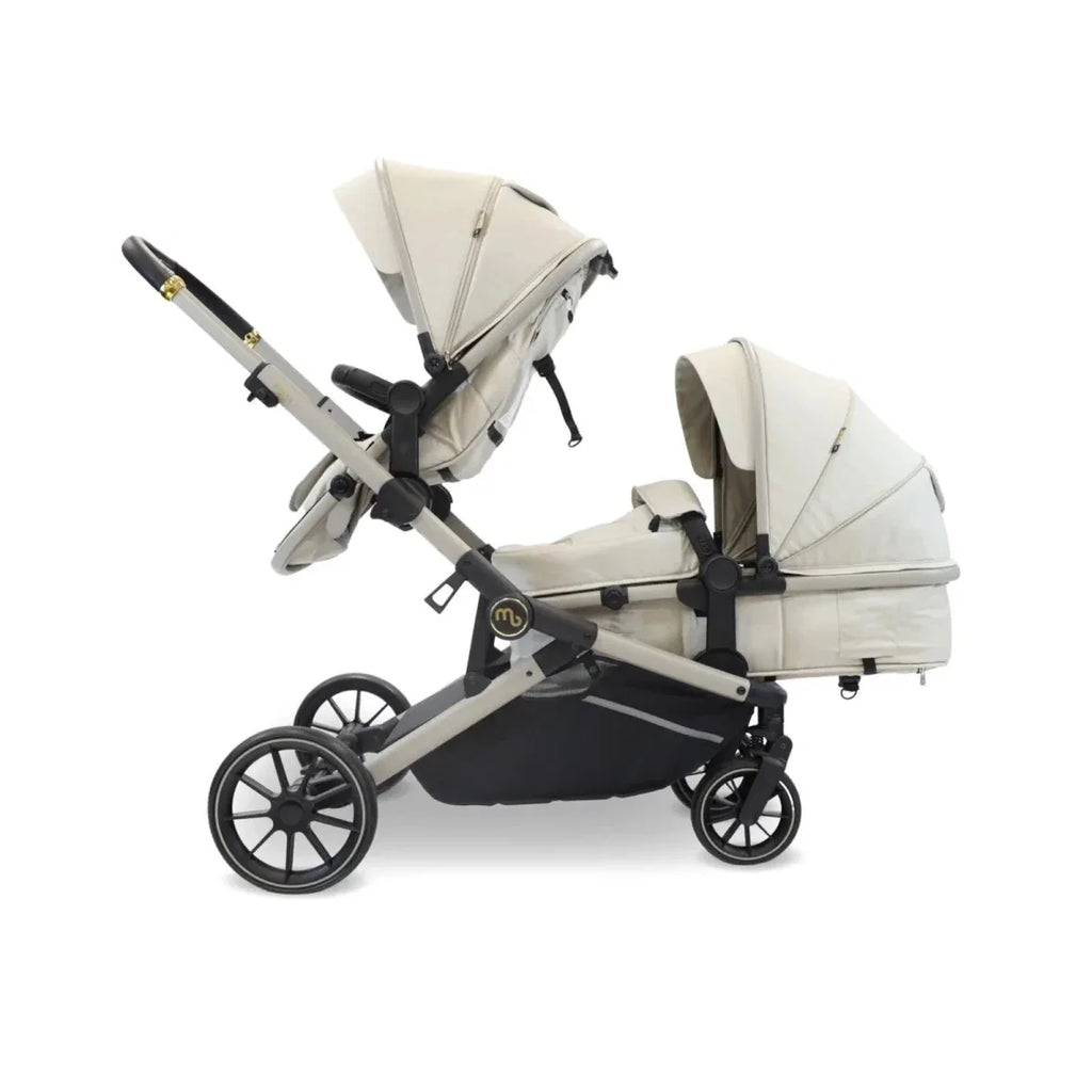 Ivory twin travel stroller with two carrycots and black underseat basket