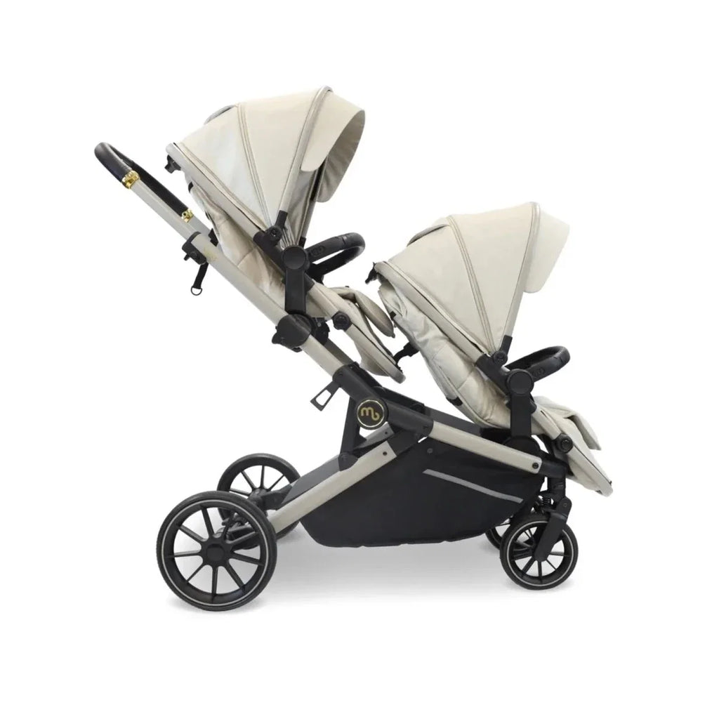 Ivory twin travel stroller with two carrycots, black base panels, and two front seats