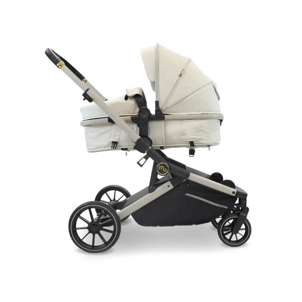 Ivory twin travel stroller with two carrycots and black seat panel, shown side view