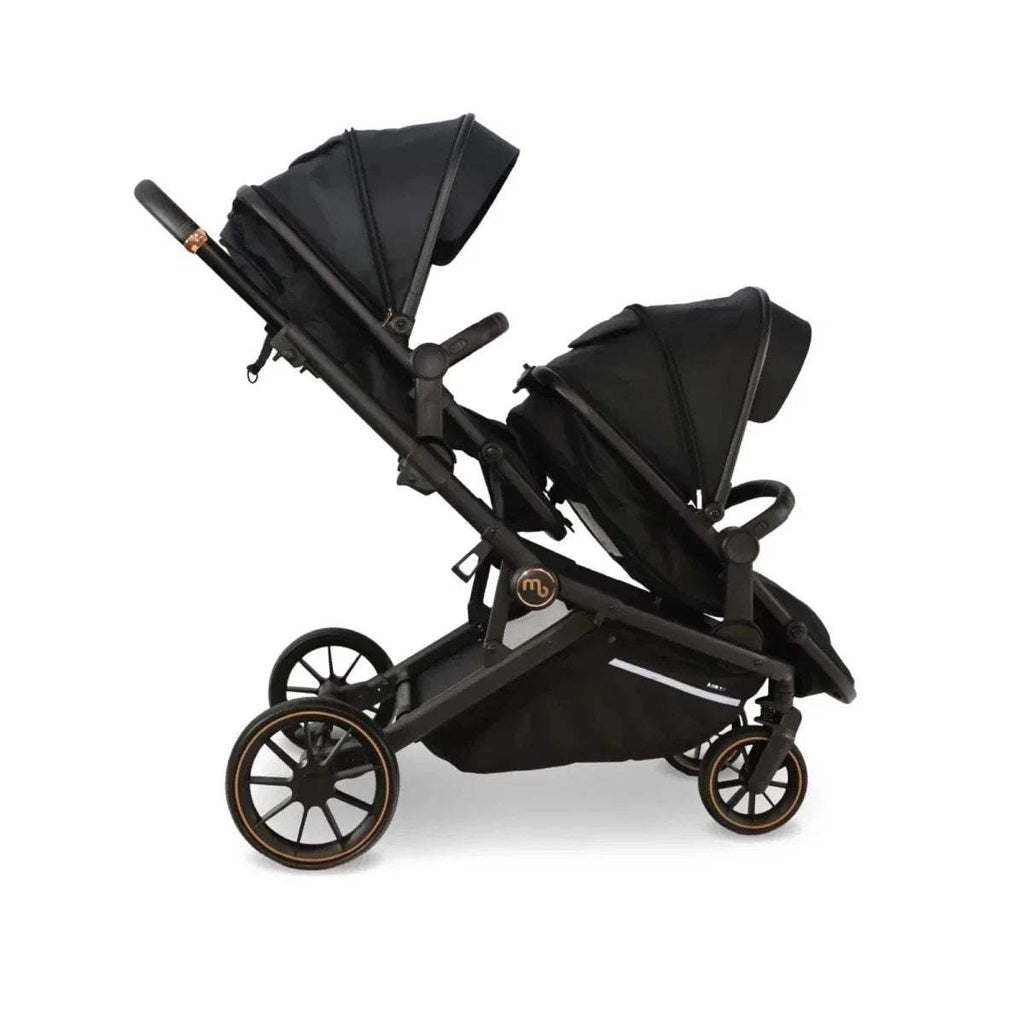 Black twin stroller with two canopy seats and tan-trim wheels, side view