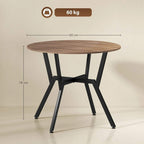 Round brown table with black steel legs, flat wood surface