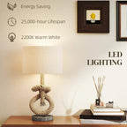 Hemp rope table lamp with cream shade and visible glowing light on base