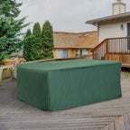 Green patio furniture cover draped over rectangular sofa table set on outdoor patio