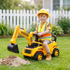 Yellow kids ride-on digger toy with front scoop digging into sand; child seated wearing helmet