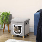 Grey cat cube bed with cushioned top, open tunnel door, and hanging ball toy