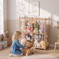 Wooden stuffed animal storage zoo with plush toys, child reaching through open front