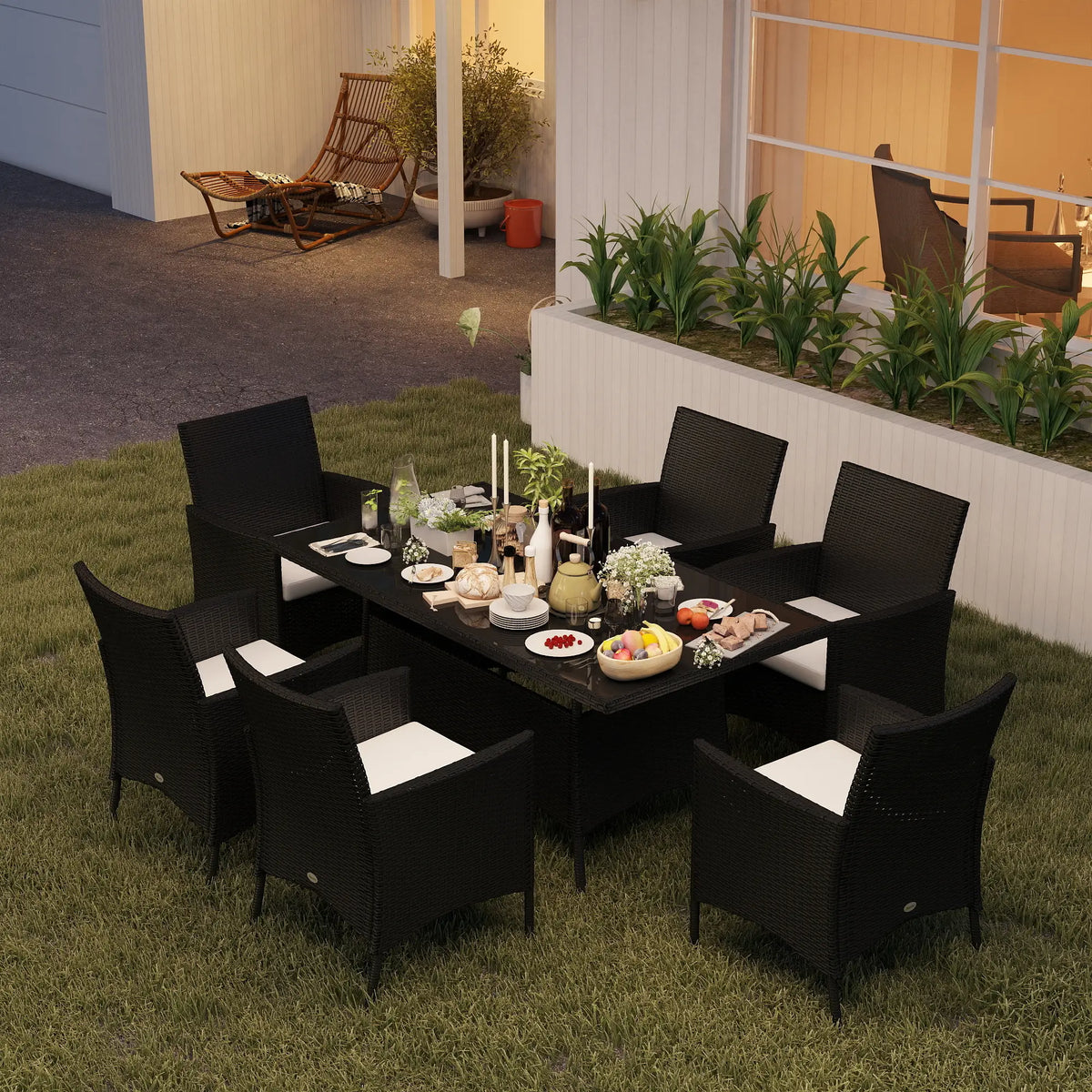 Black rattan dining set with six white-cushioned armchairs around a table