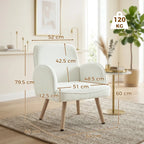 Cream velvet armchair side view with rounded back, padded seat cushion, and wooden legs