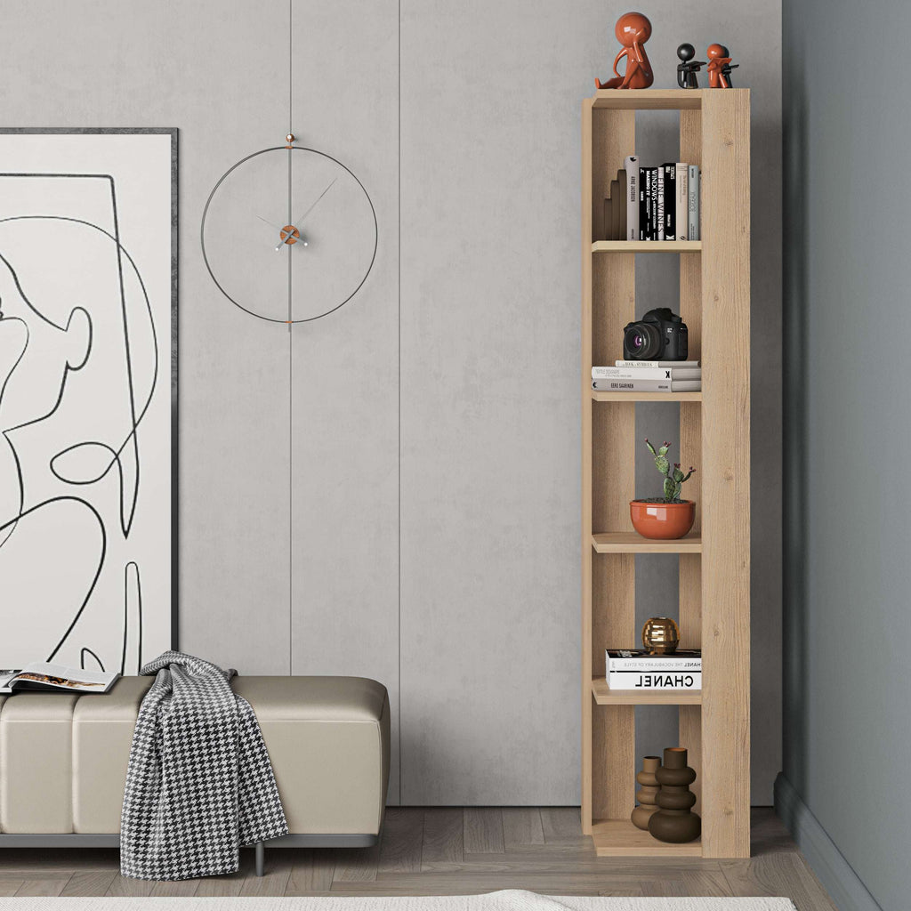 Tall narrow oak bookcase with open shelves, styled with books, camera, and decor pieces.
