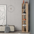 Tall narrow oak bookcase with open shelves, styled with books, camera, and decor pieces.