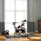 Black fitness mat placed under an exercise bike to protect floors