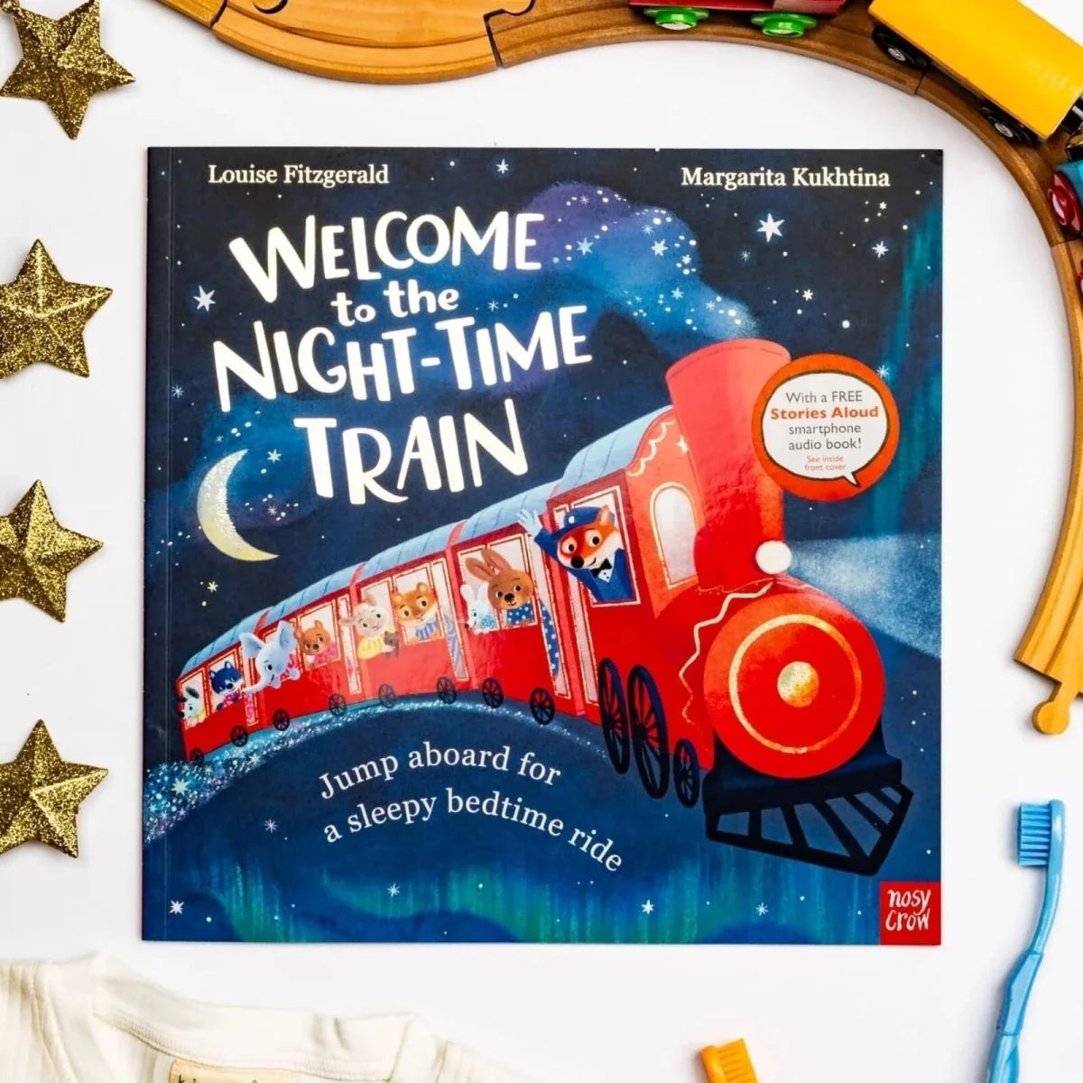 Children's picture book cover showing red locomotive train under stars