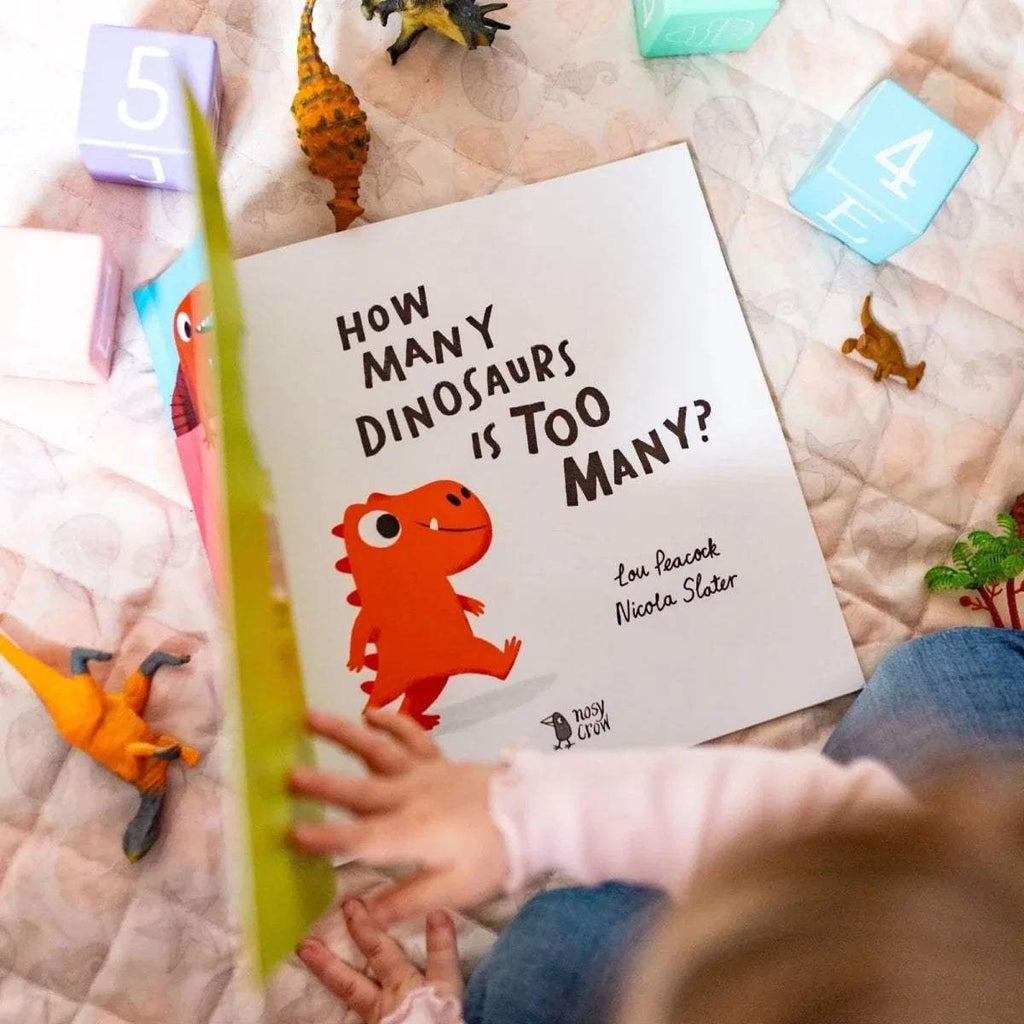 Children's picture book with front cover showing dinosaur characters and bold title