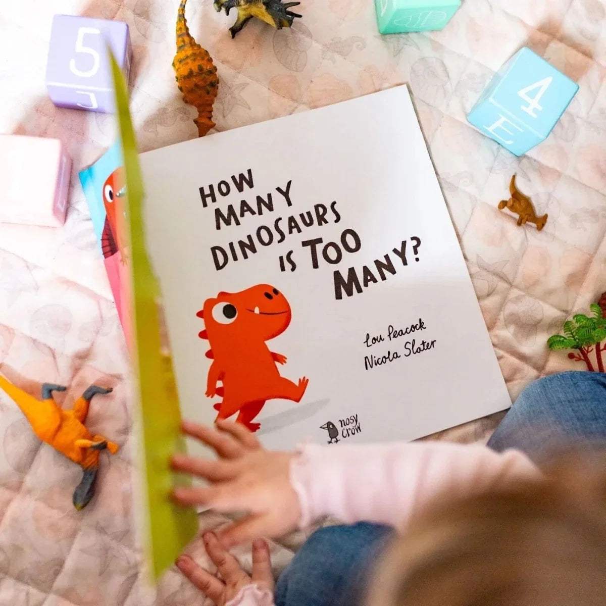 Children's picture book with front cover showing dinosaur characters and bold title