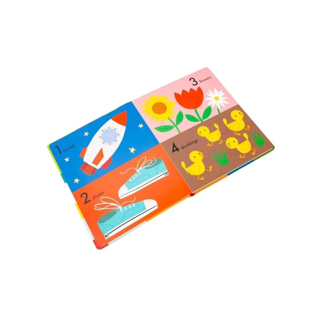 Open children’s lift-the-flap board book pages with rocket and duck figures