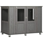 Grey dog crate table with front double doors, metal handles, and raised feet