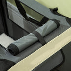 Close-up of folded cushion insert with elastic strap on a grey foldable pet carrier
