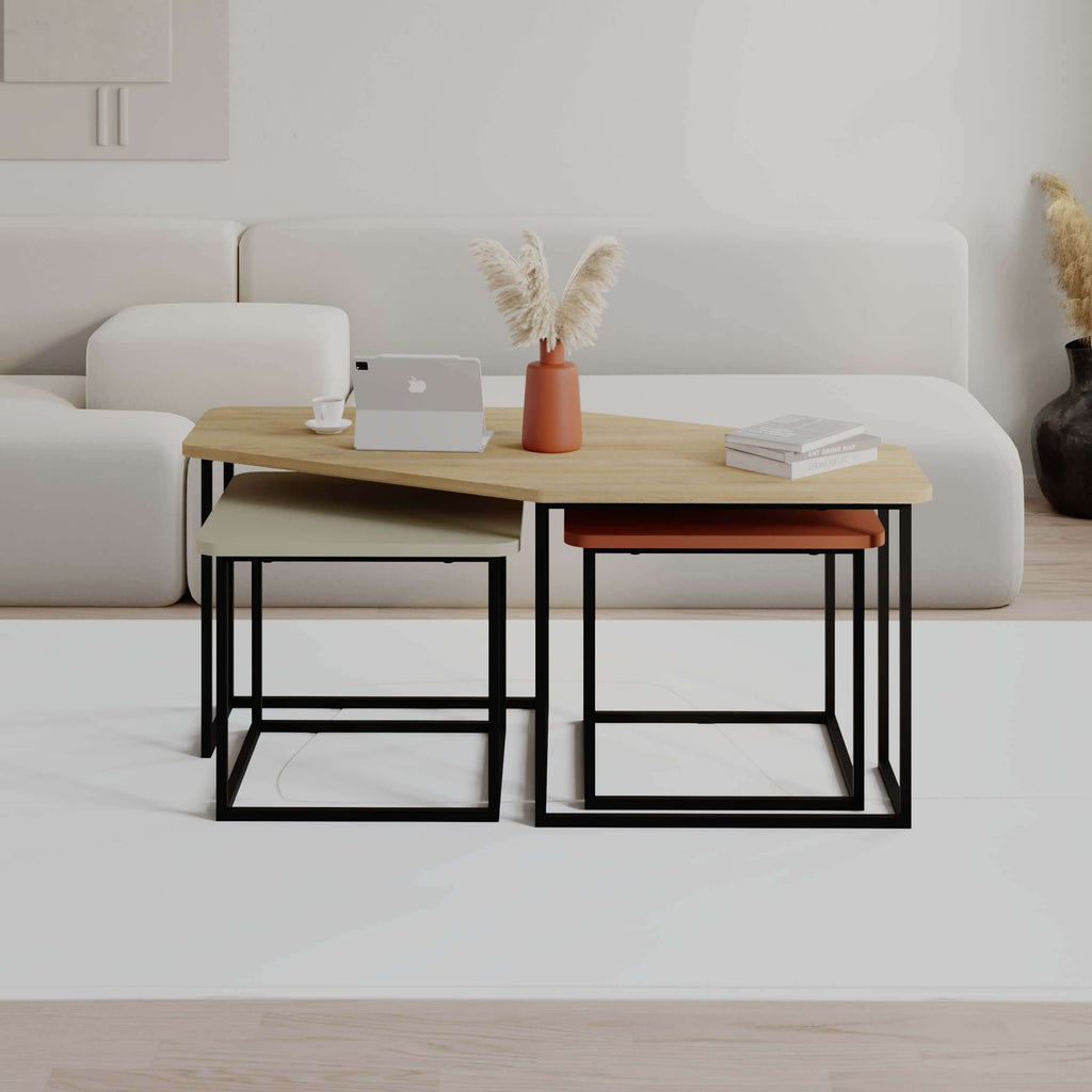 Modern coffee table set with light wood tabletop, black metal frames, resting on sofa