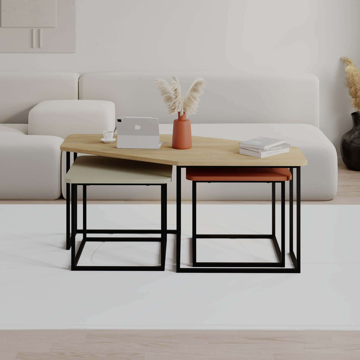 Modern coffee table set with light wood tabletop, black metal frames, resting on sofa