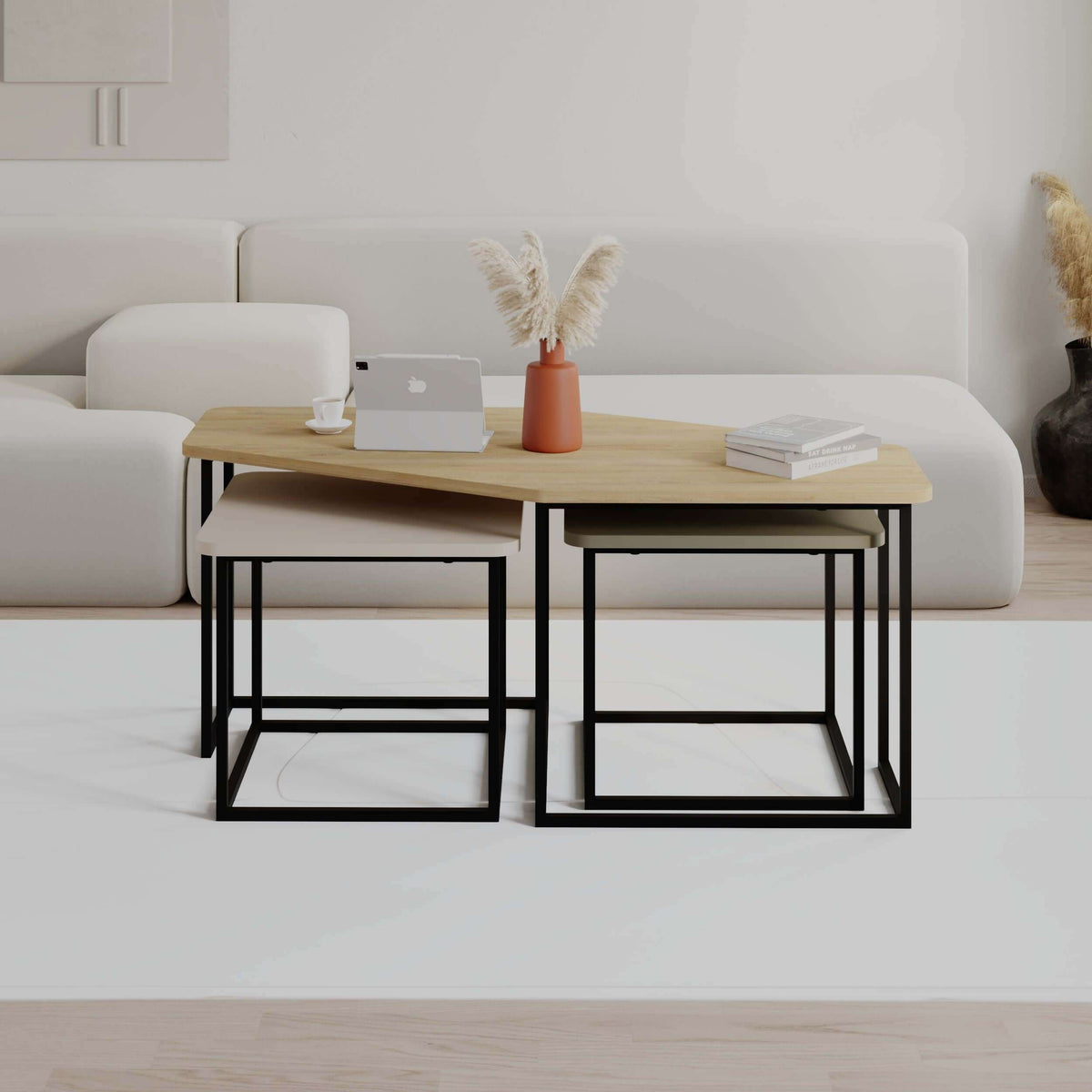 Nesting coffee table set with light wood tabletop and black metal base in front view