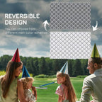 Reversible outdoor rug showing gray and white trellis pattern on both sides