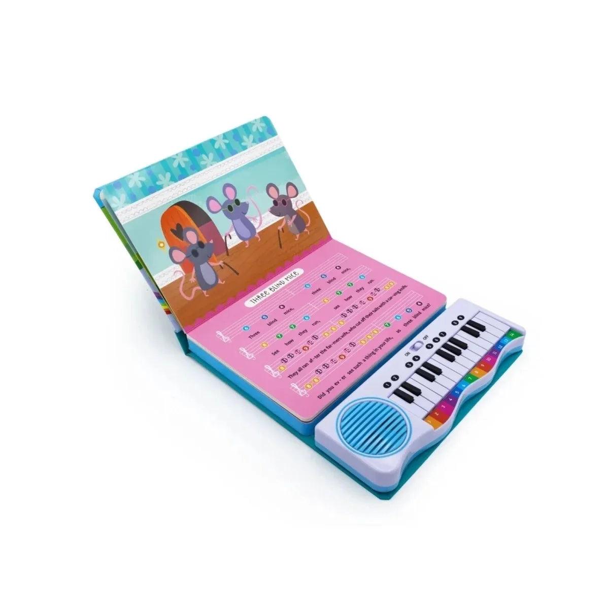 Open musical piano book with illustrated characters and mini keyboard with speaker