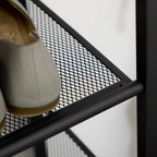 Black mesh shelf panel with metal frame, slanted shoe rack rail