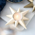 Cream star candle holder with round tealight cup centered in the star