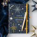 Sparkly A5 notebook with dark navy cover, gold constellation print, and matching yellow pen