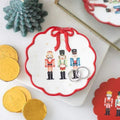 Nutcracker trinket dish with red scalloped rim, bow topper, and nutcracker family design