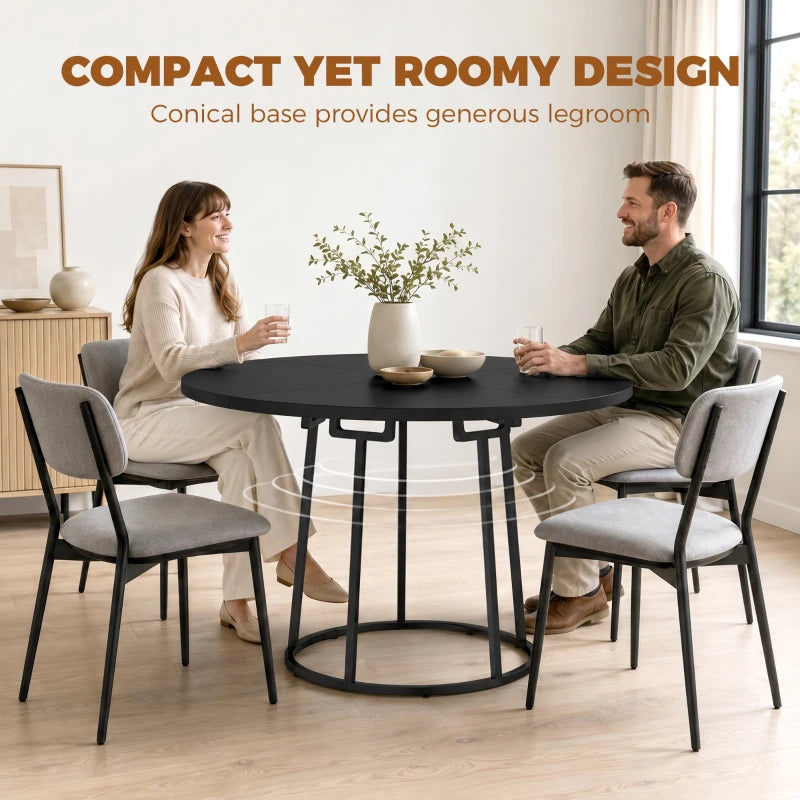 Round black dining table with conical metal base and compact round top