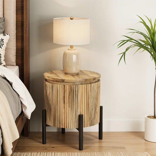 Round solid wood bedside table with vertical grain finish and black metal legs