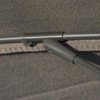 Close-up of grey parasol fabric edge and rib support connection to pole