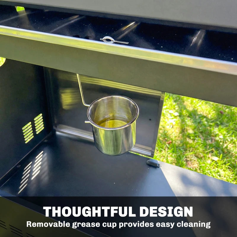 Interior of BBQ grill with removable grease cup in lower drip tray