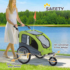 Green three-wheel dog bike trailer being pushed with canopy and safety flag