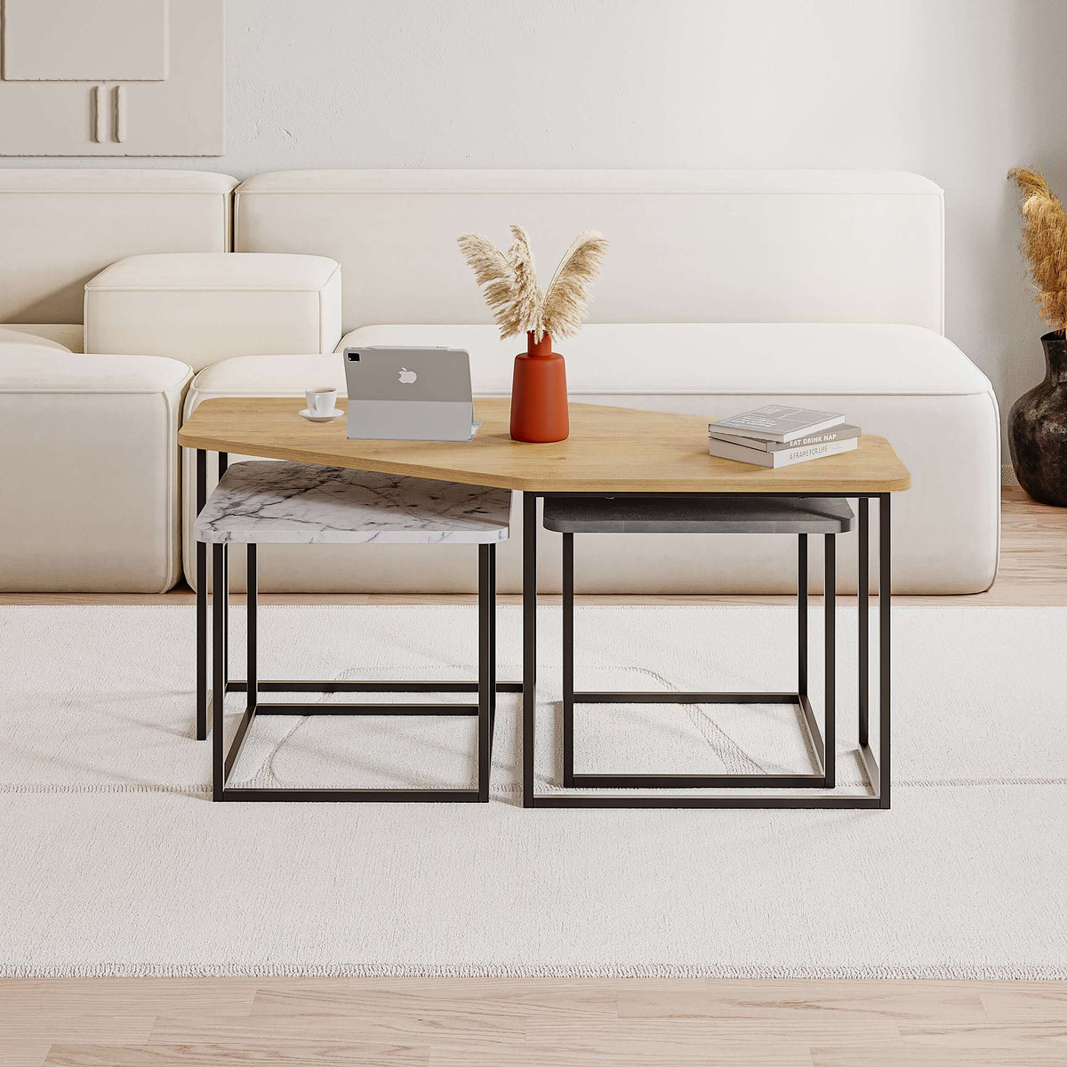 Nesting coffee table set with light wood tabletop, black steel legs, and shelf bases